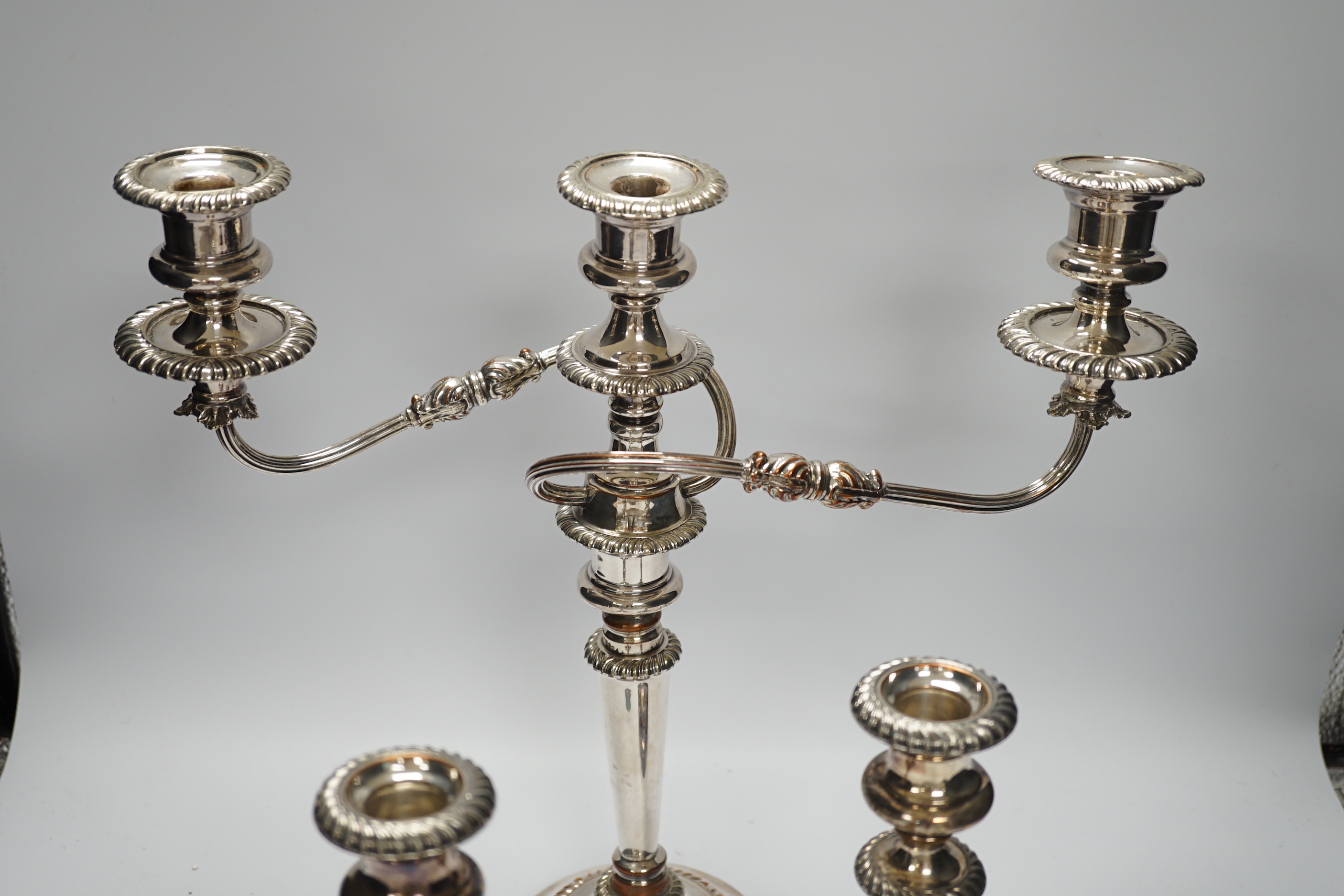 A Sheffield plate two branch, three light candelabra and a pair of candlesticks, candelabra 36cm high